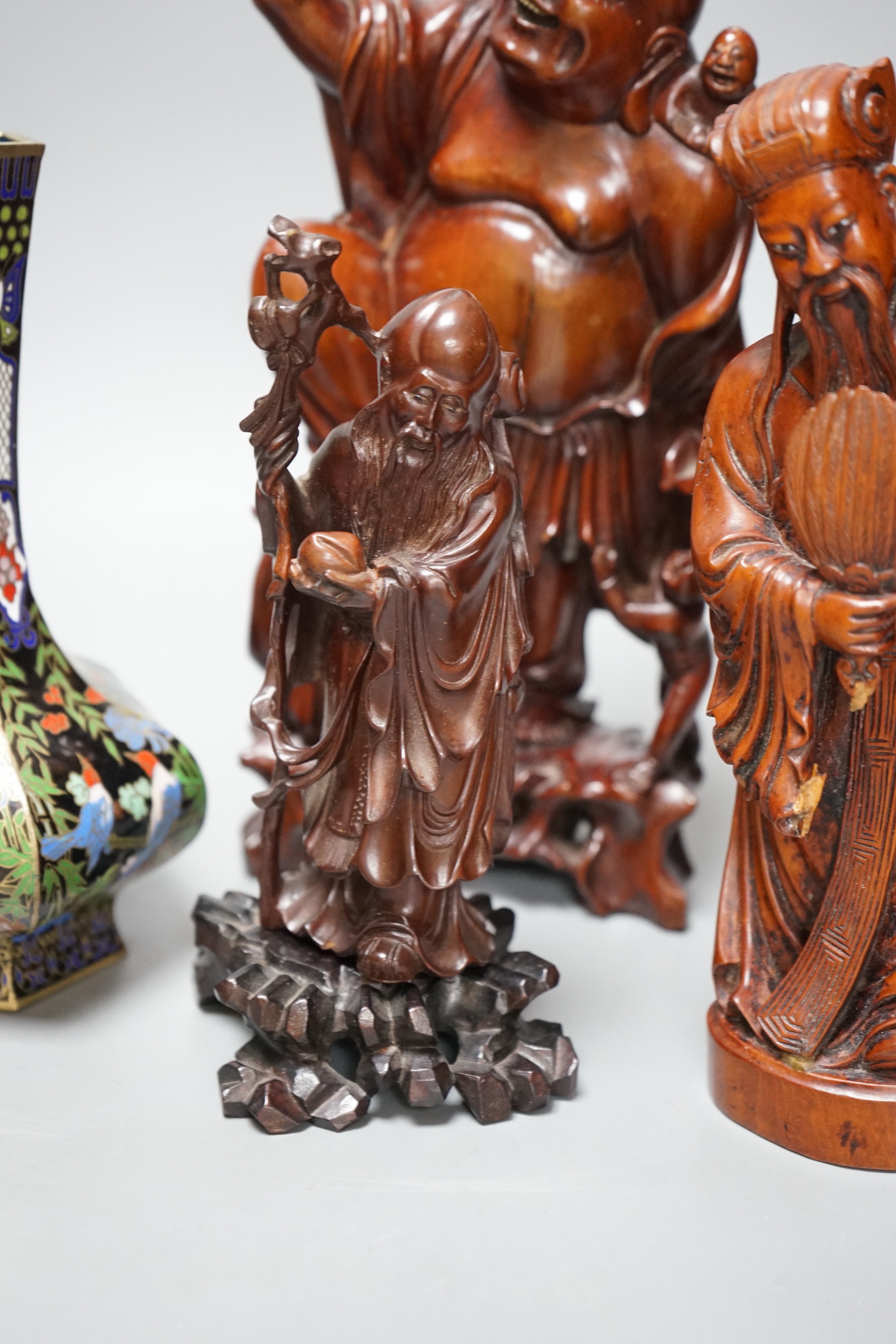 Two Chinese champlevé enamel vases, a soapstone carving and three early 20th century Chinese carved hardwood figures, tallest 26cm